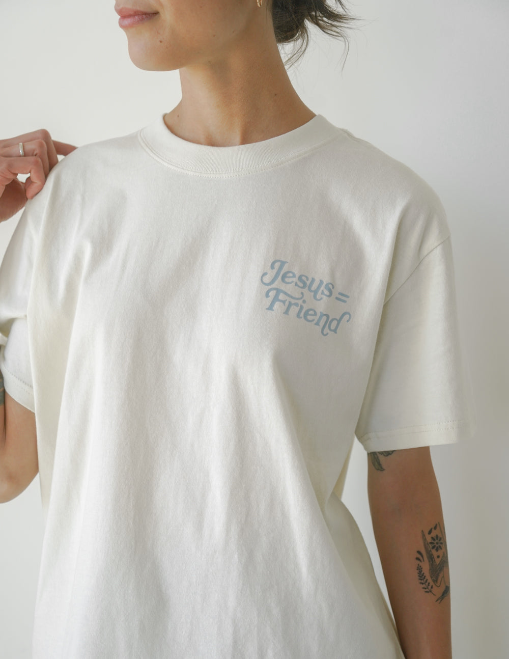 White unisex crew-neck tee with 'Jesus Friend' logo on chest, short sleeves.