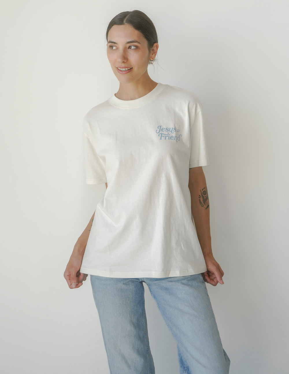 White unisex crew-neck tee with small 'Jesus Friend' text at right chest.