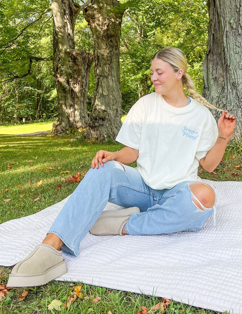 White unisex tee with faint 'Jesus Friend' text graphic, crew neck, short sleeves.