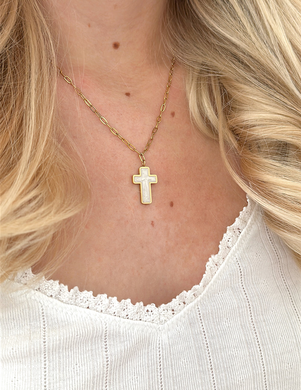 Gold cross necklace with white enamel cross pendant on fine link chain