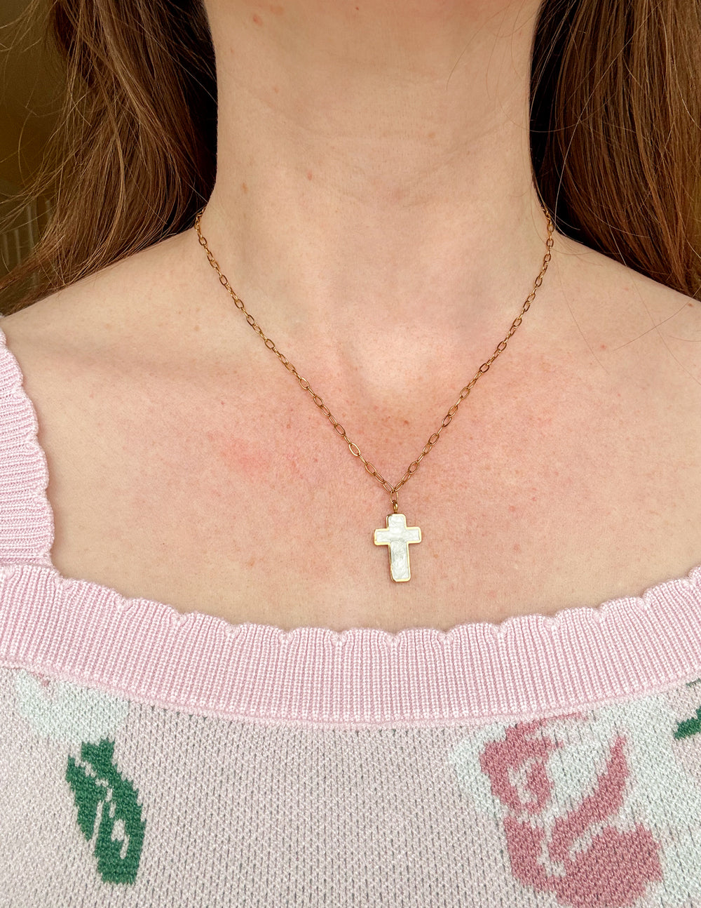 Gold cross necklace with white enamel cross pendant on link chain