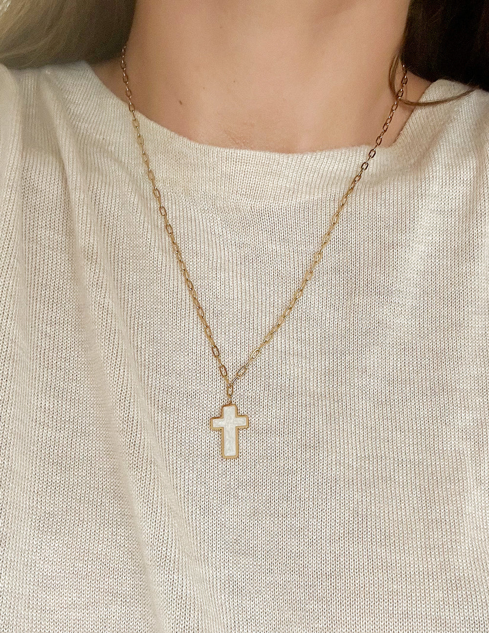 Gold cross necklace with white enamel cross pendant on link chain