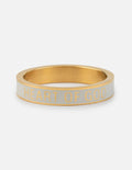 White enamel ring with gold band and embossed text reading HEART OF GOD