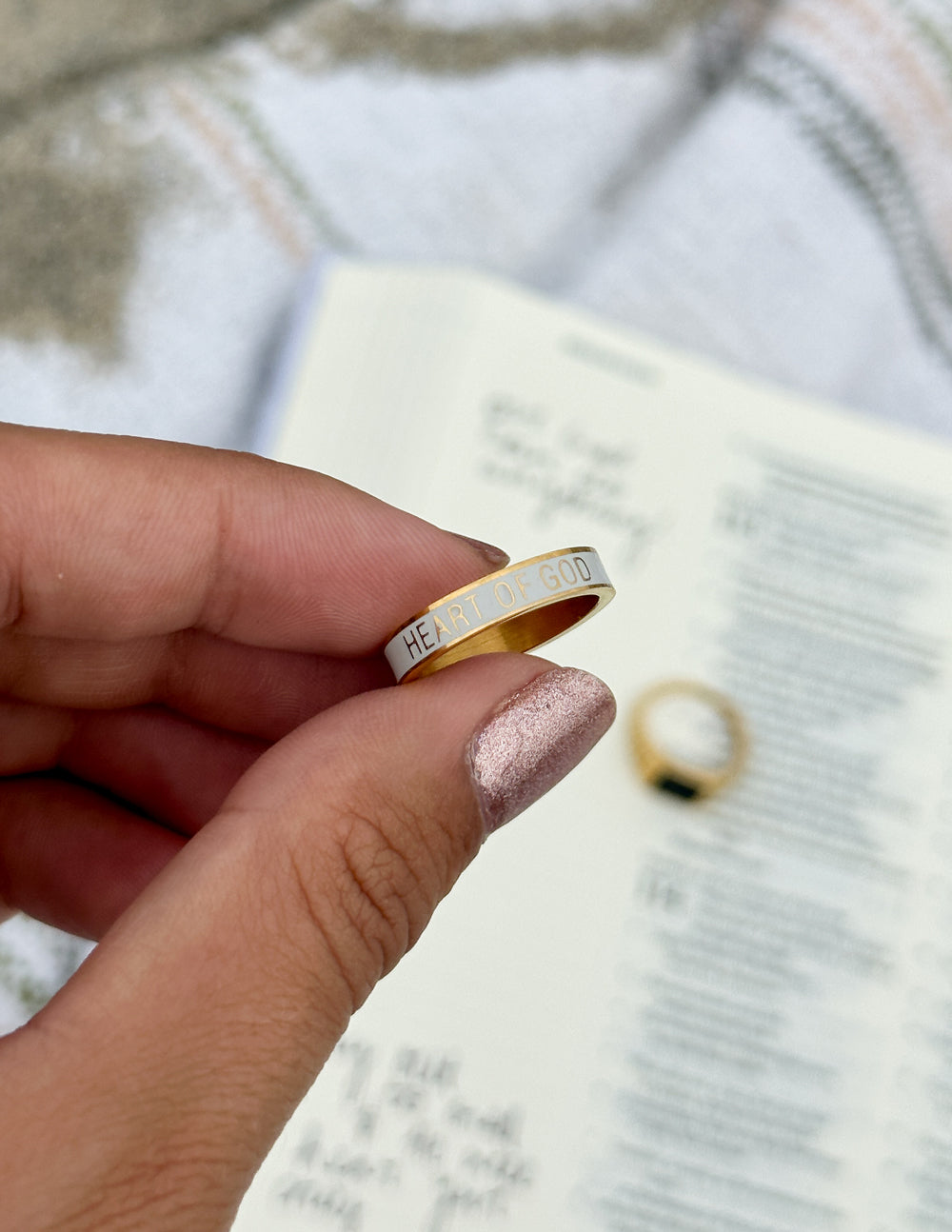 White enamel signet-style ring with raised gold HEART OF GOD text