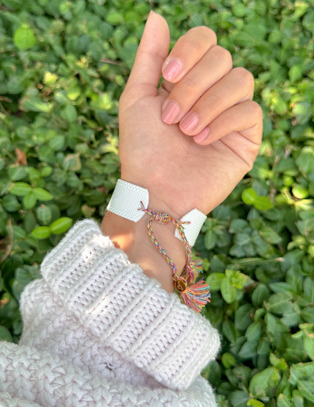 White woven bracelet with turquoise and red embroidery and braided tassel ties