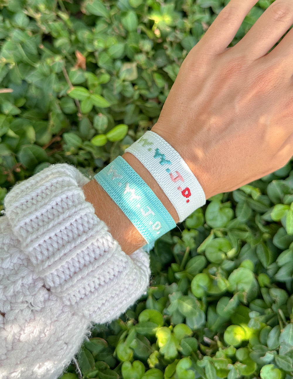 Light blue embroidered bracelet with turquoise and red pattern on wrist