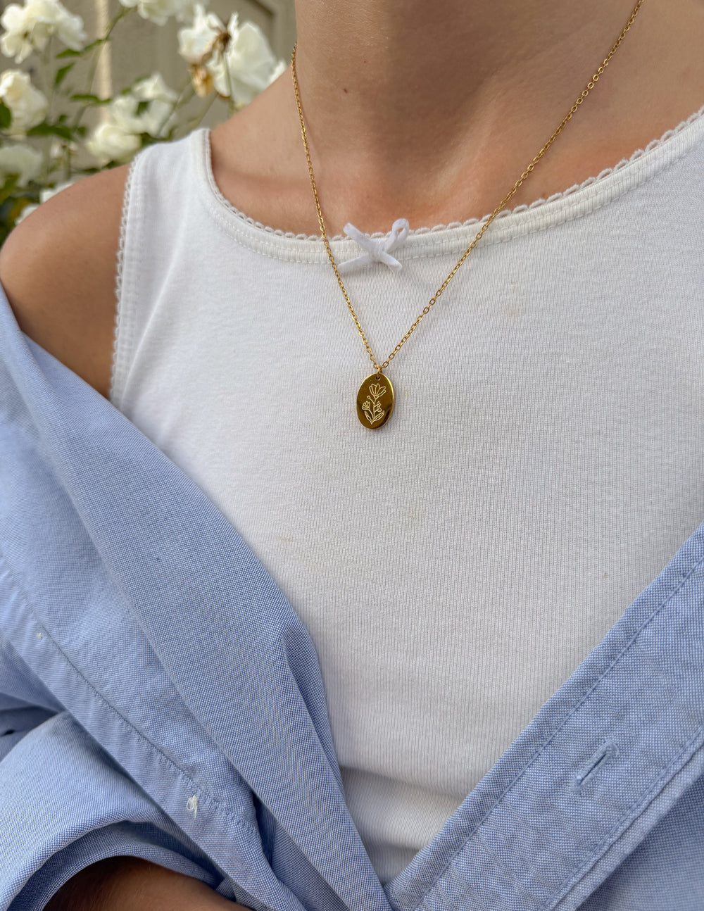 Gold-tone oval link necklace with small engraved oval pendant on chain