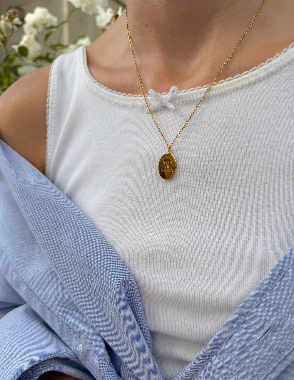 Gold-tone oval link necklace with engraved oval pendant, hanging center