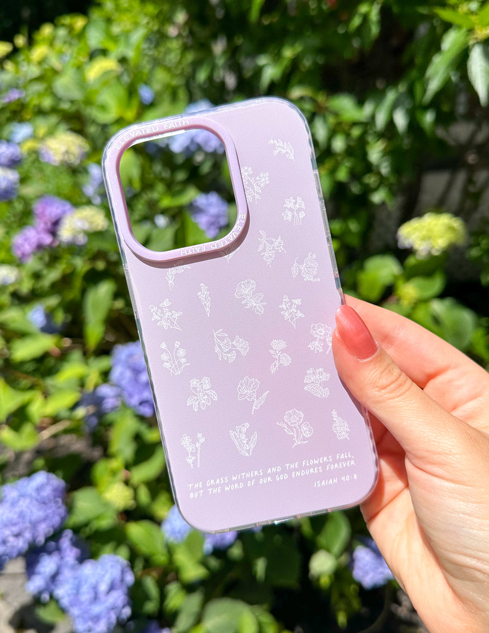 Lavender phone case with white wildflower pattern, side view with hand