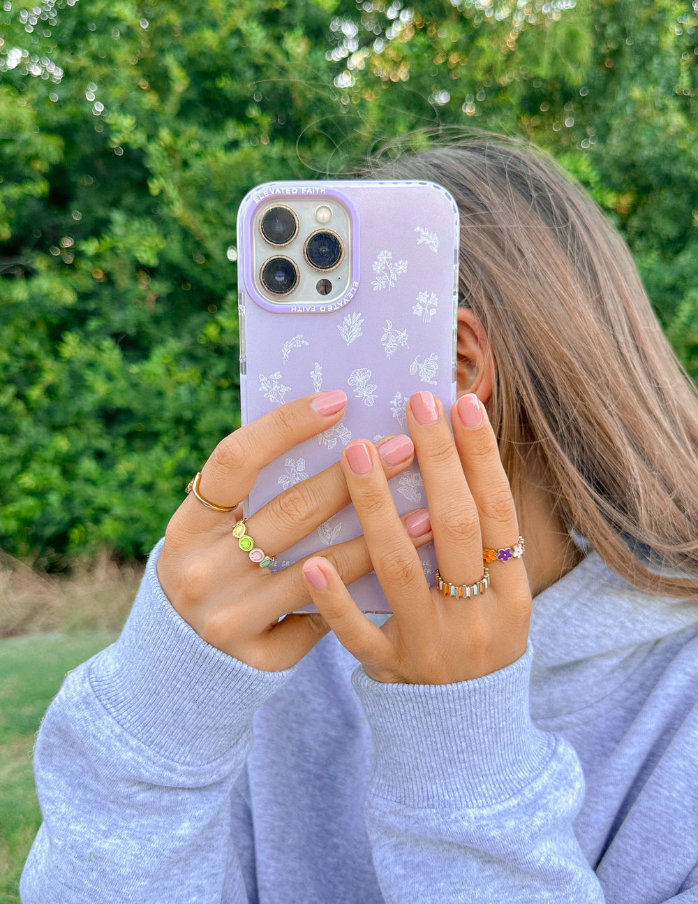 Lavender phone case with white wildflower pattern covering camera area