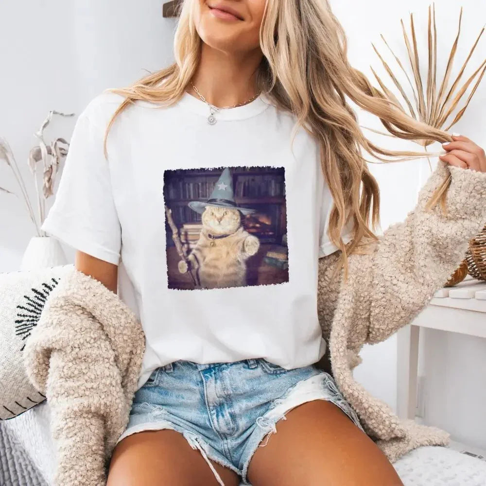 White cat wizard Halloween graphic tee with square printed cat scene on model