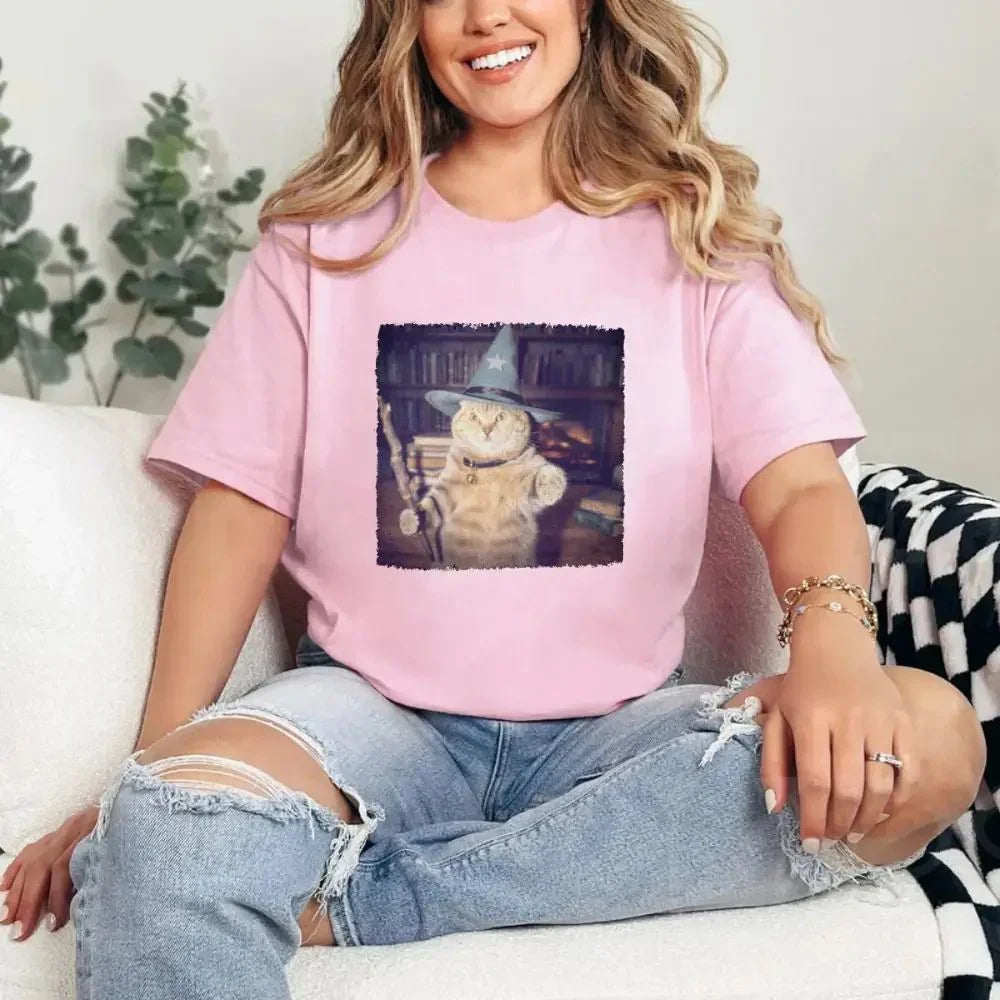 Pink cat wizard Halloween graphic tee on model with square printed cat scene