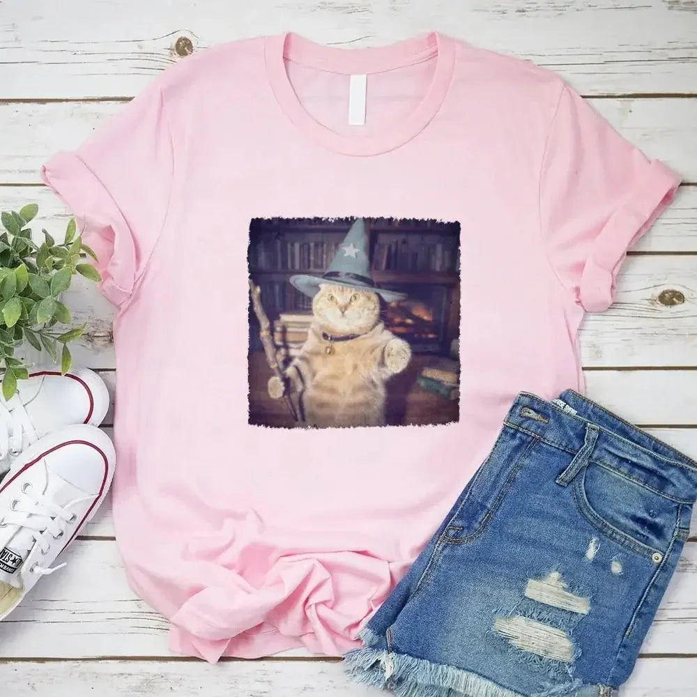 Pink cat wizard Halloween graphic T-shirt with square cat print, paired with denim shorts