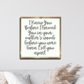 Framed wood sign with handwritten scripture text, beige background, dark wood frame.