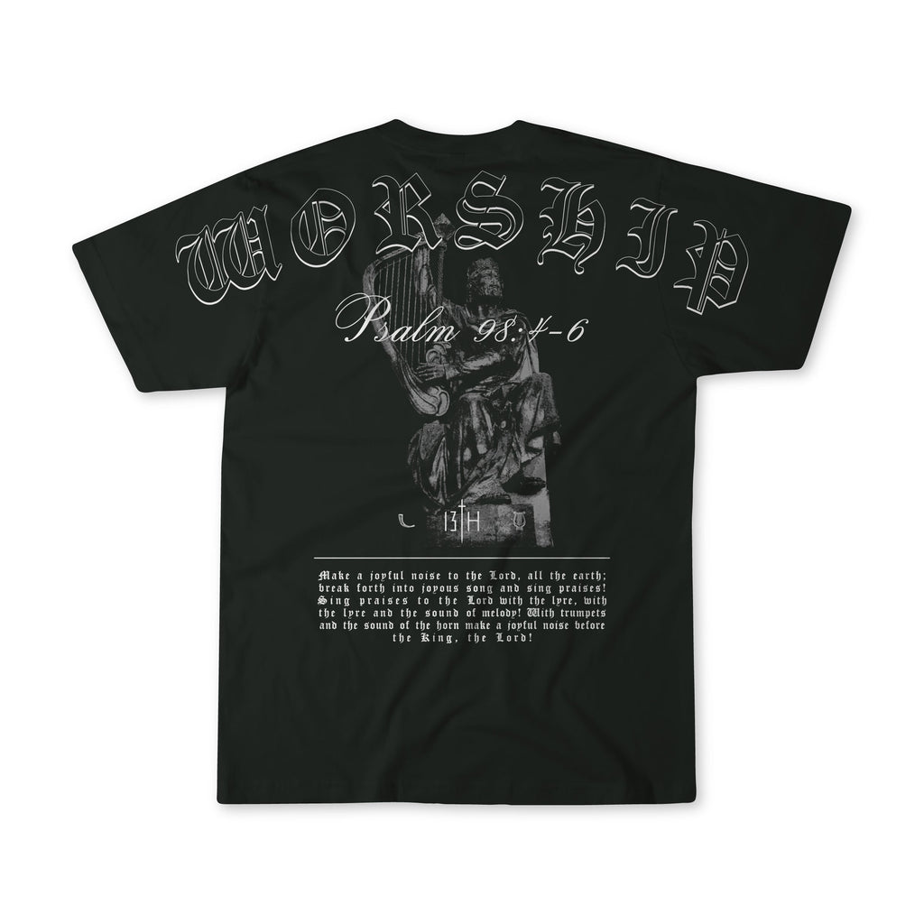 Black oversized tee with large front graphic: portrait illustration and ornate lettering.