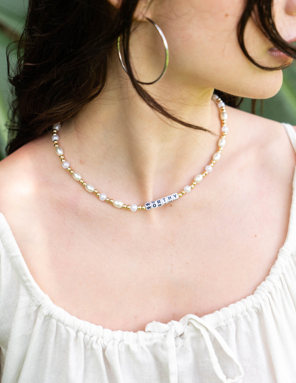 Letter necklace with gold-tone beads and white pearls, 'WORTHY' bar center