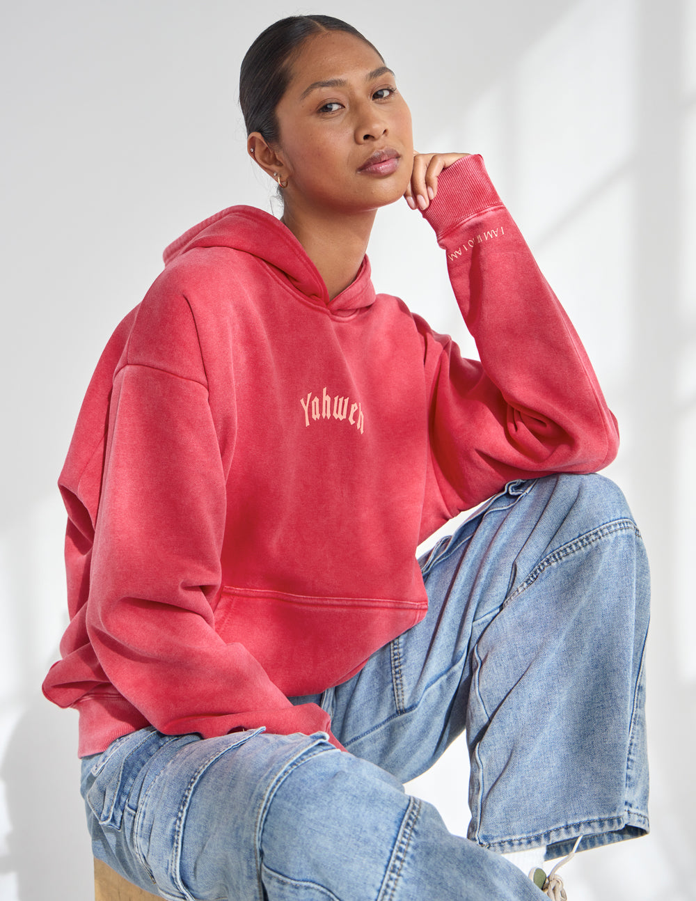 Red unisex hoodie with kangaroo pocket, hood, and small chest logo.