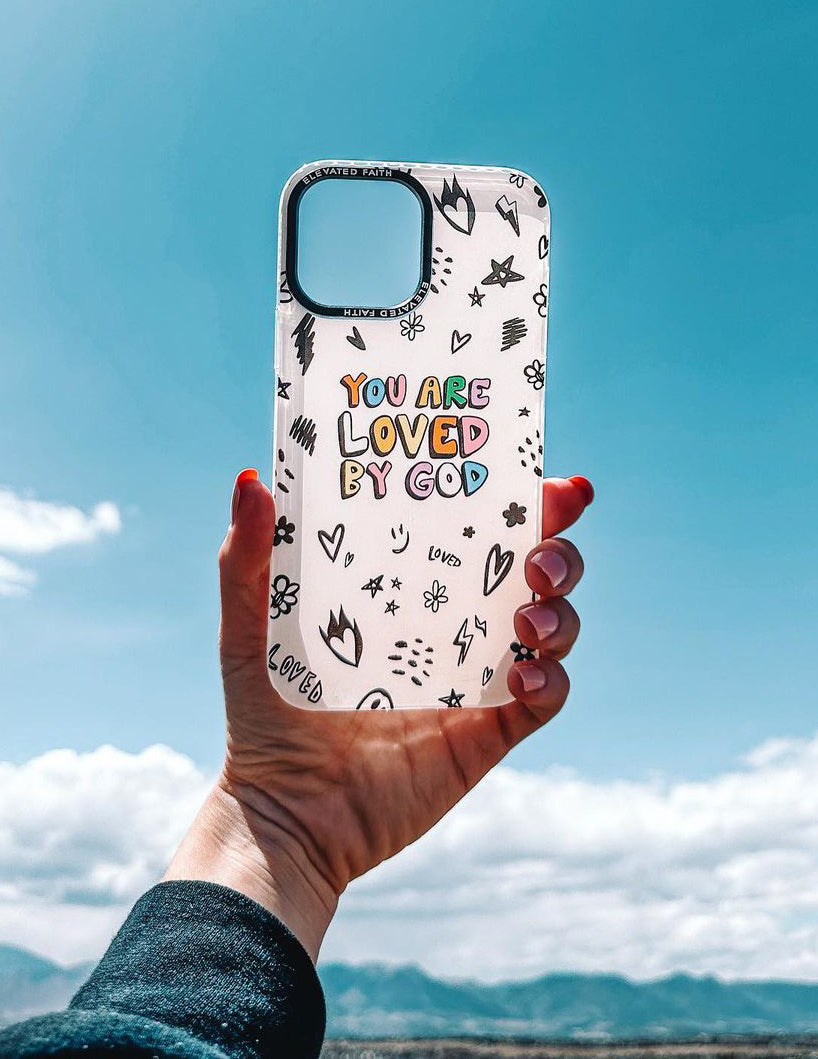 White phone case with 'You are loved by God' text and black symbol pattern