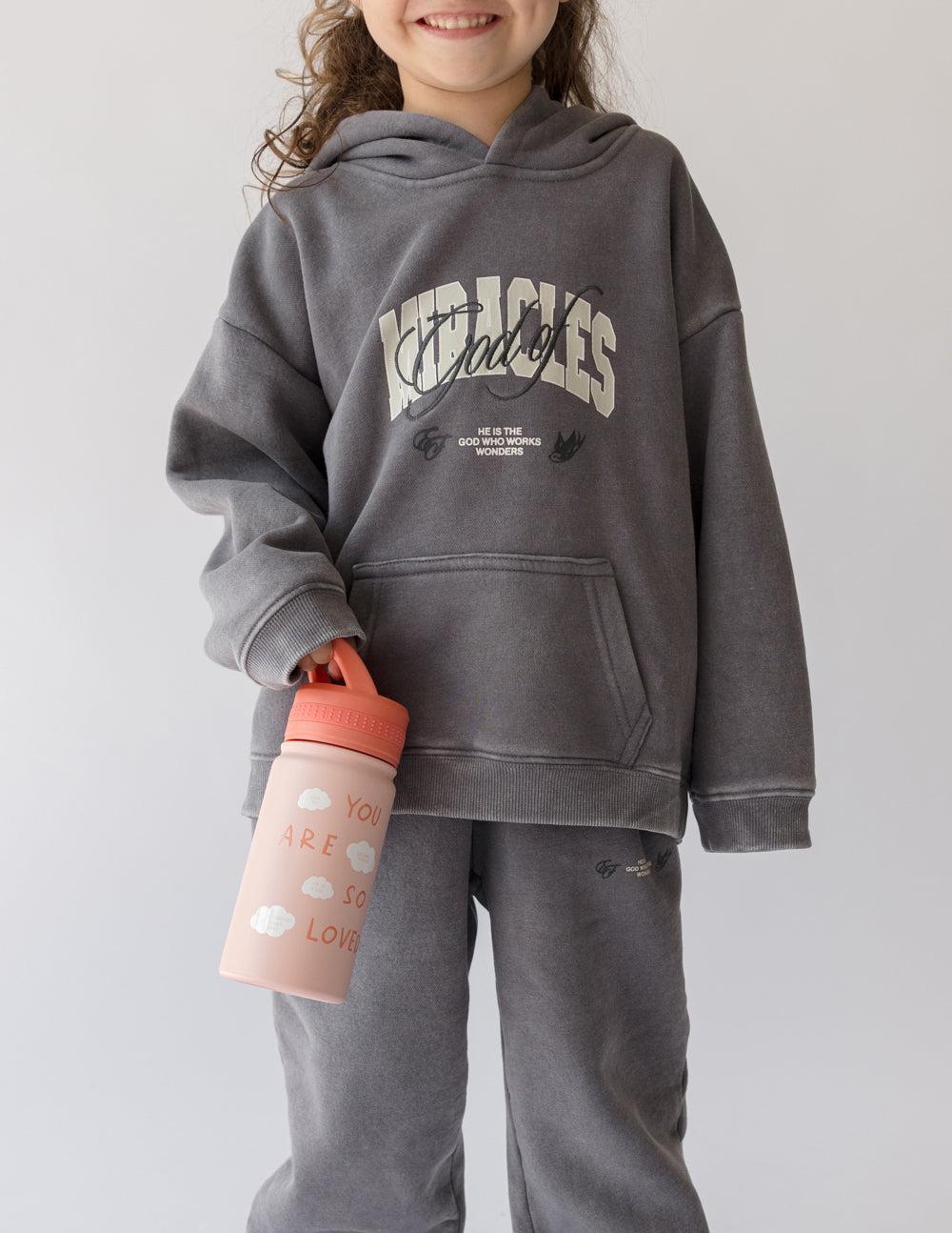 Pink kids water bottle with orange lid and "You are so loved" wording on front.