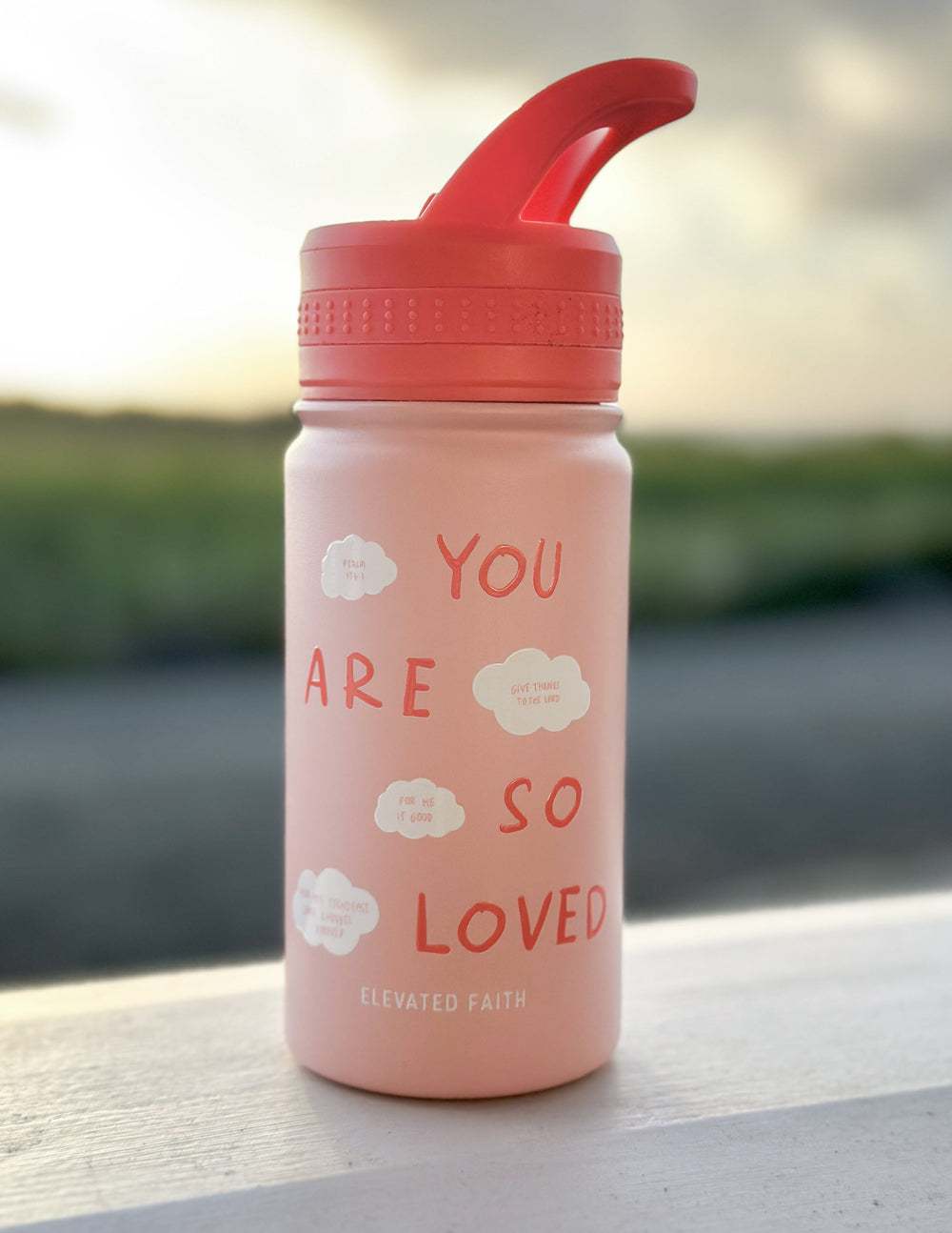 Pink kids water bottle with orange flip-top lid, front "You are so loved" text.