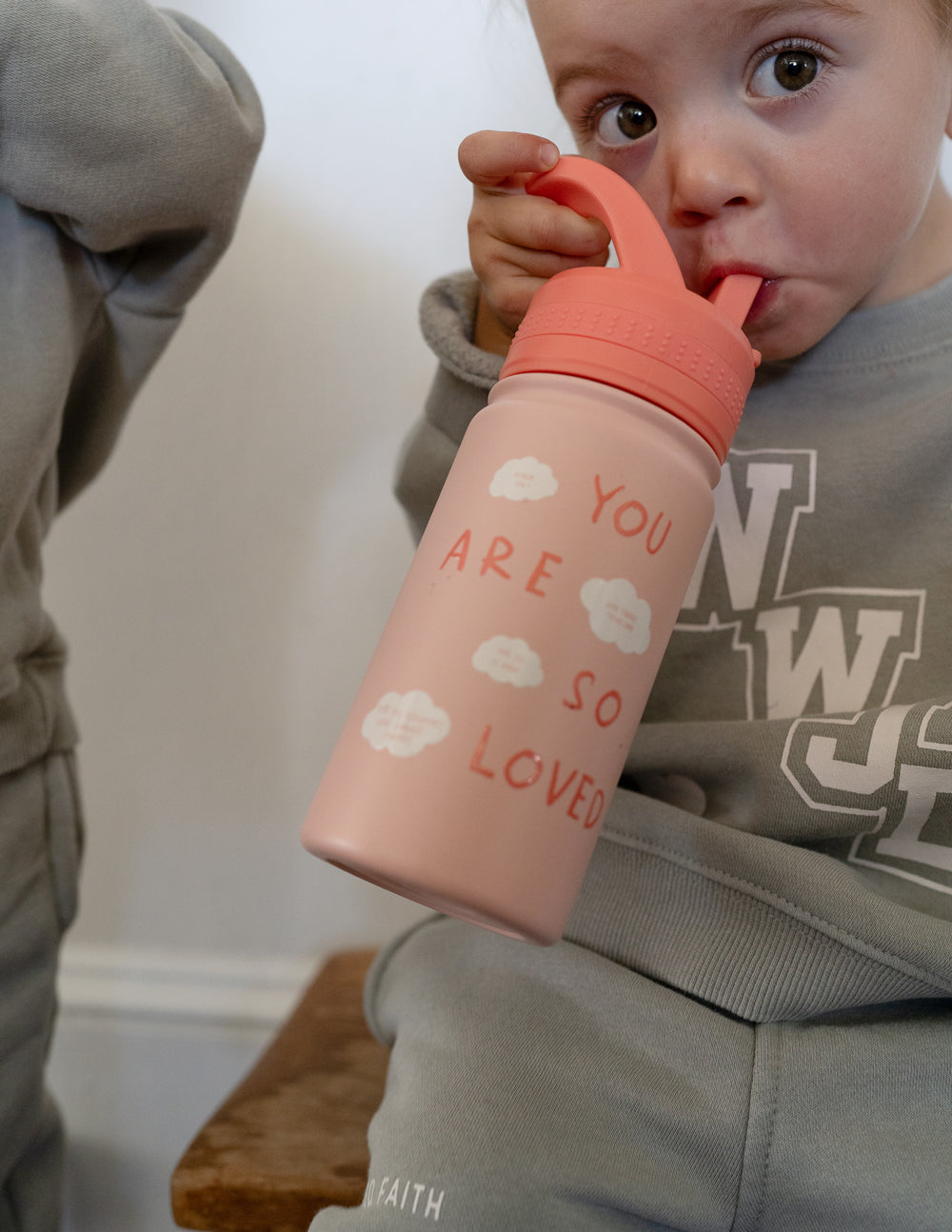 Kids water bottle, pink with orange flip-top lid, "You are so loved" print.