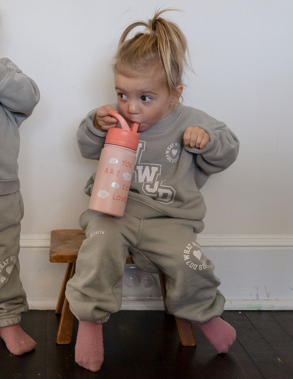 Kids water bottle in pink with orange flip-top lid, "You are so loved" text.