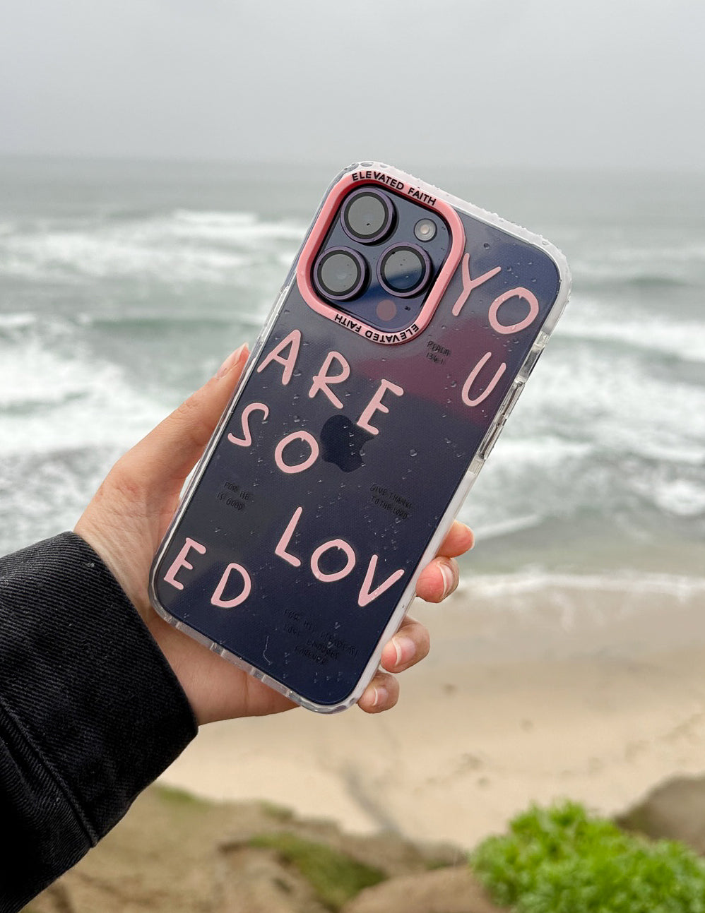 Dark phone case insert with pink trim, pink lettering, and four camera cutouts