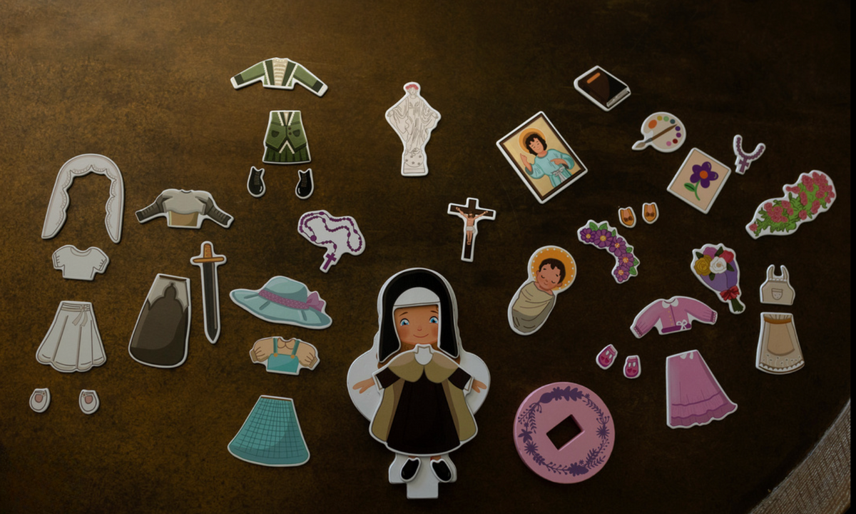 Magnetic wooden dress-up doll set with nun doll and assorted magnetic outfits and accessories