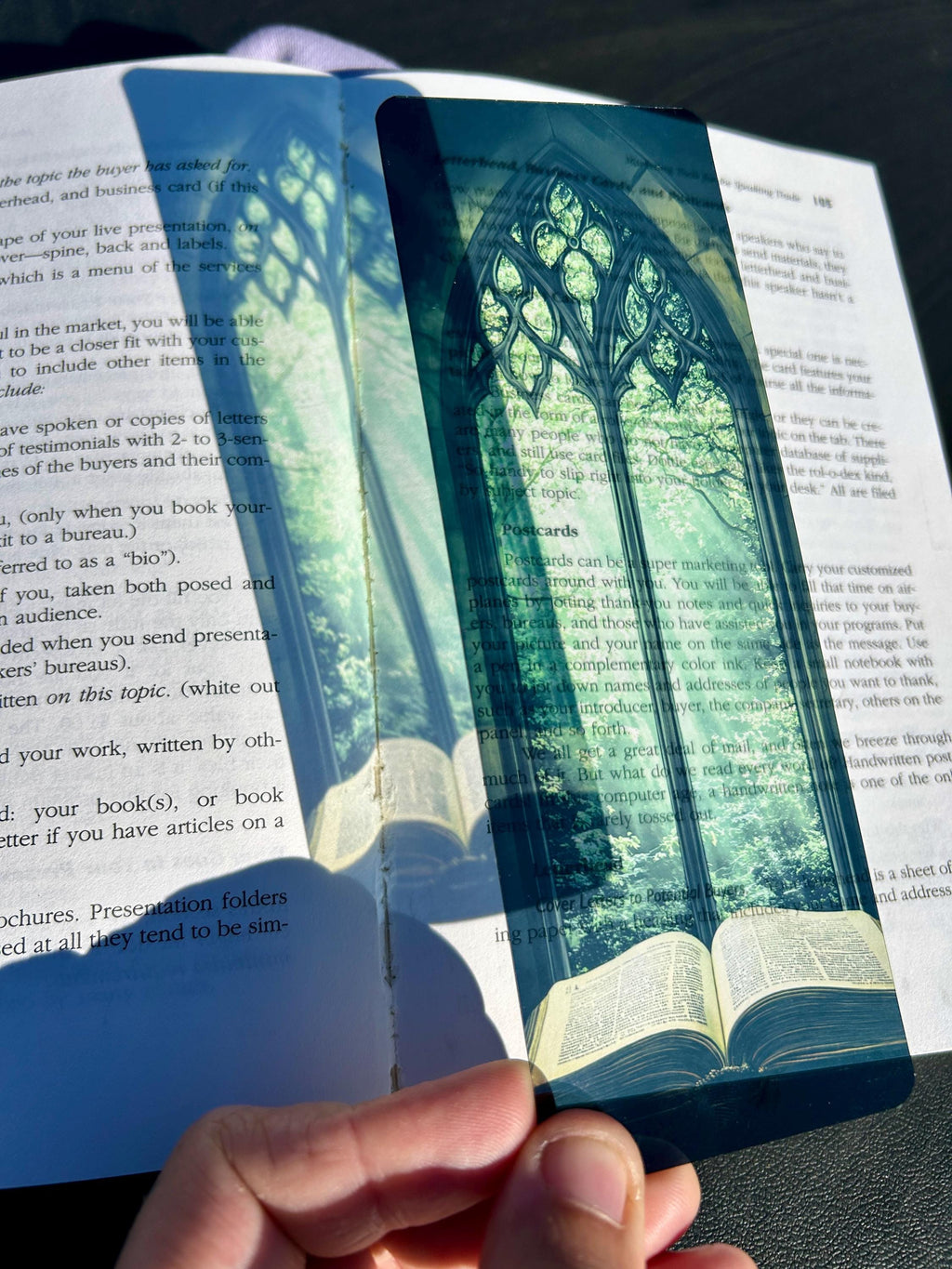 Stained glass arched bookmark with green tree canopy design over open book
