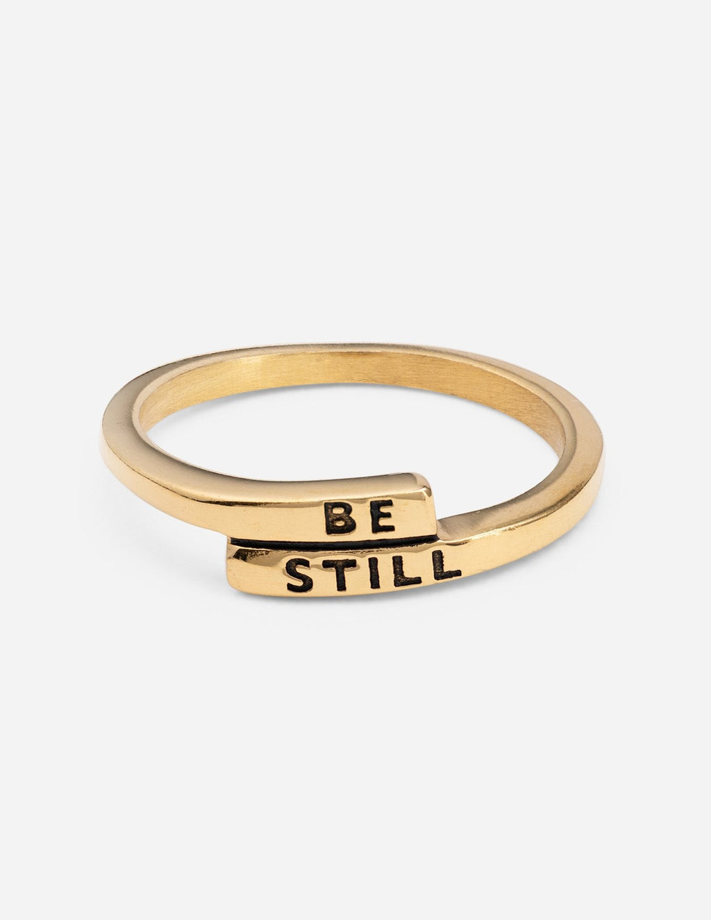 Wide gold ring with "BE STILL" engraving