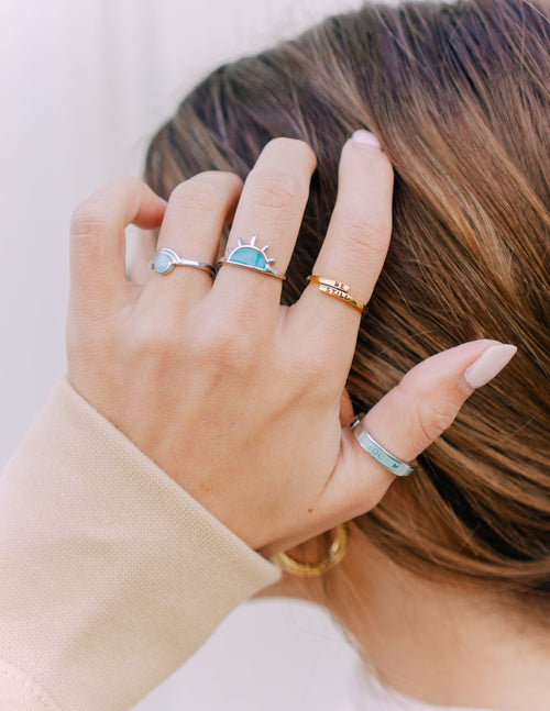 Gold tone ring with light blue enamel oval centerpiece
