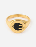 Gold-tone ring with black enamel dove motif on a raised oval setting