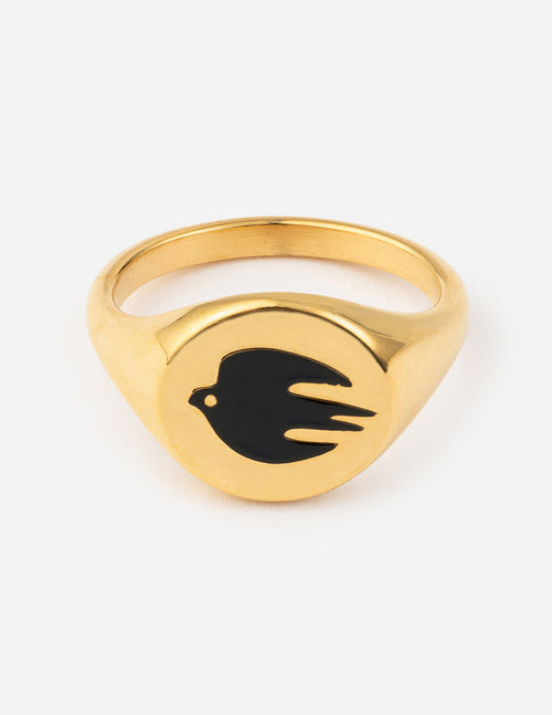 Gold-tone ring with black enamel dove motif on a raised oval setting
