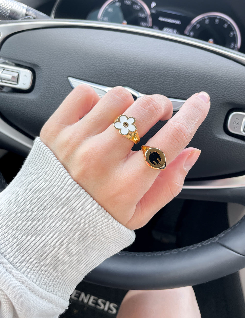 Gold-tone dove ring with black enamel bird silhouette on a knuckle