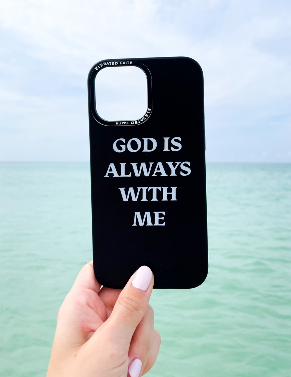 Black phone case with 'God is always with me' text and camera cutouts.