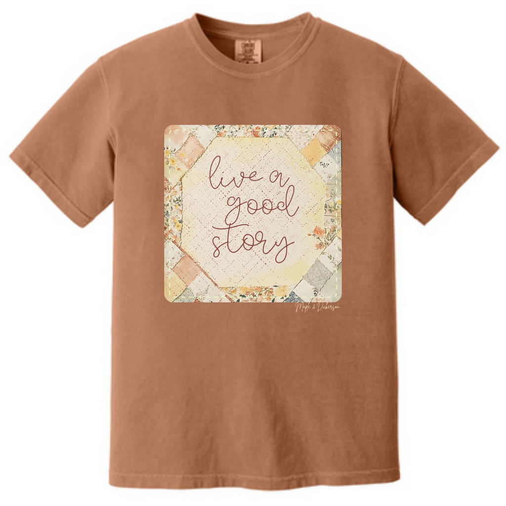 Brown crewneck T-shirt with front graphic: 'live a good story'