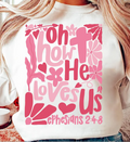 White sweatshirt with large pink 'Oh How He Loves Us' graphic