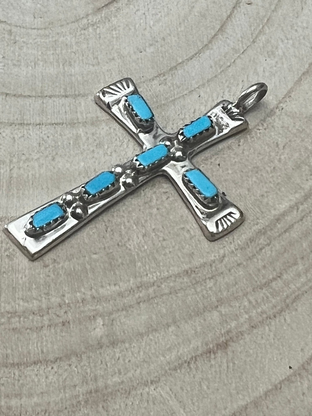 Turquoise cross pendant with silver-tone settings and blue rectangular inlays.