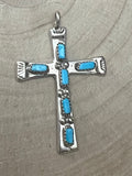 Turquoise inlay cross pendant with silver-tone bezel and four blue stones.