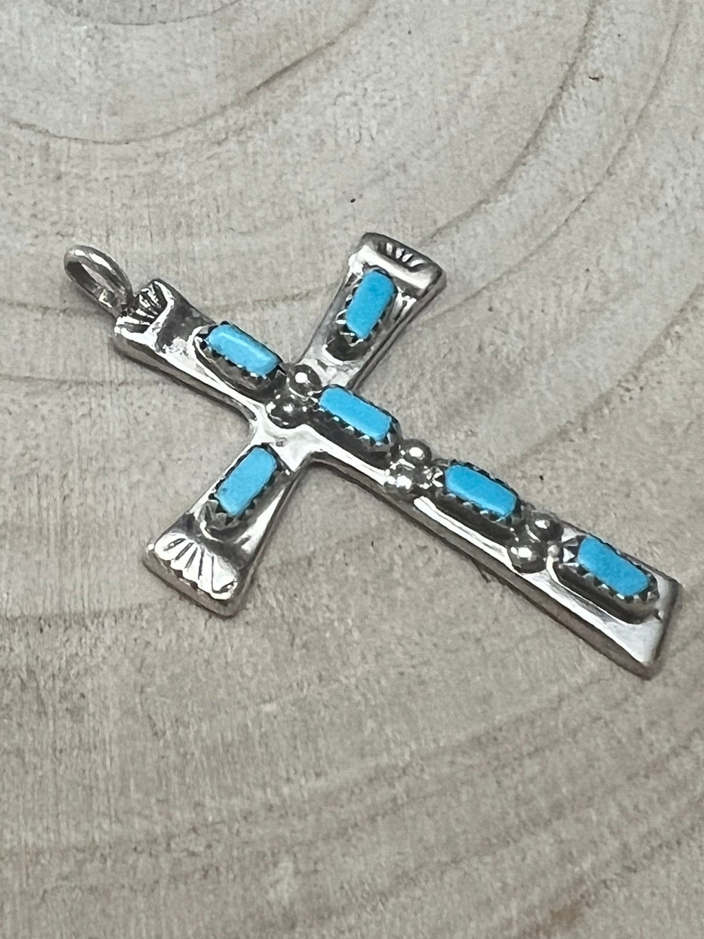Turquoise cross pendant with silver-tone frame and blue rectangular stones on arms.