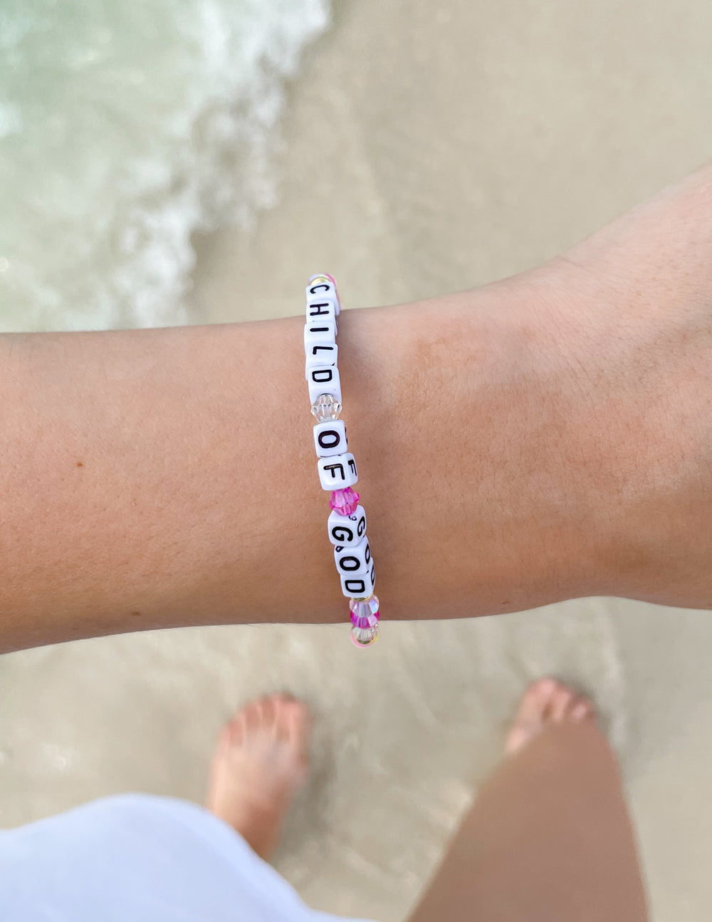 Child of God letter bracelet with blue-striped beads and pink flower accents