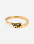 Gold ring with black enamel text reading 'CHOOSE JOY' on the band