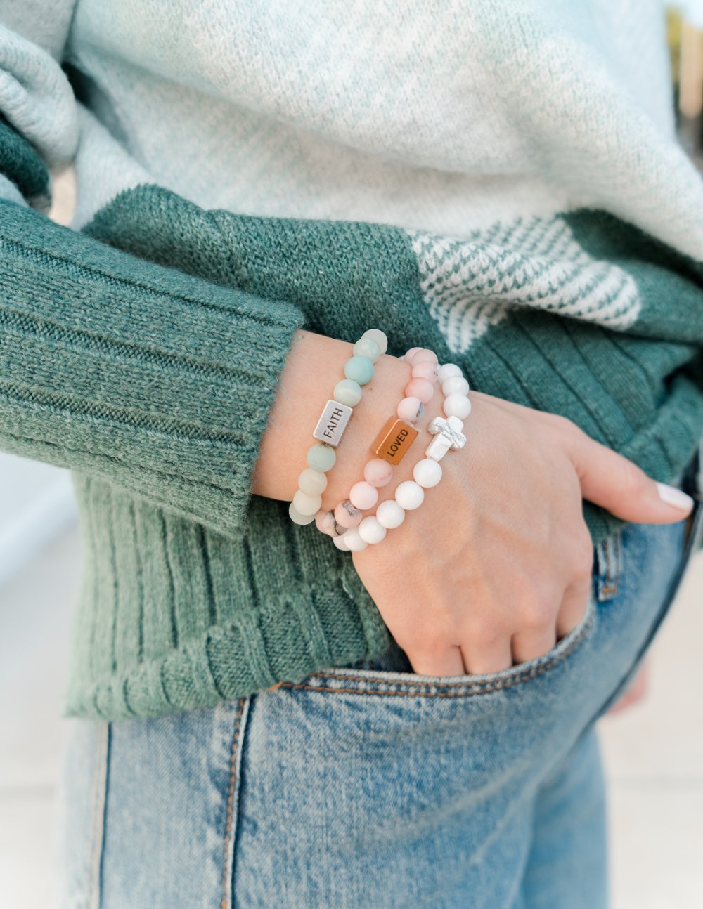Beaded bracelet with small white tag charm, on wrist