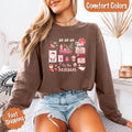 Brown long sleeve Christmas shirt worn with blue denim, featuring "Ho Ho Ho" "Tis the Season" art