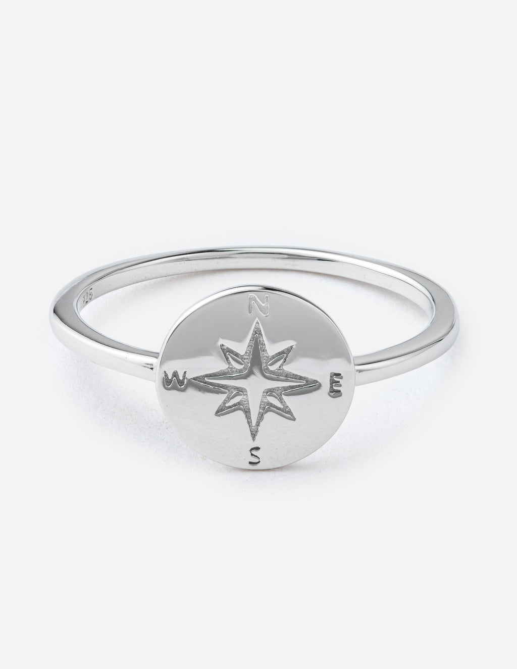 Silver compass ring with star emblem and direction letters