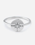 Silver compass ring with star emblem and direction letters