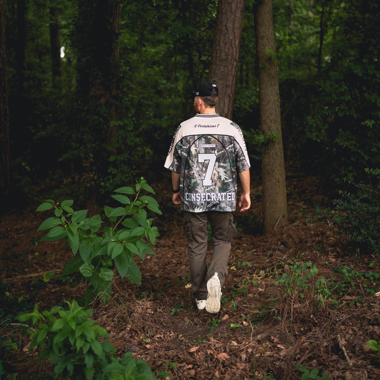 Oversized jersey back view with woodland camo pattern and number 7, worn outdoors