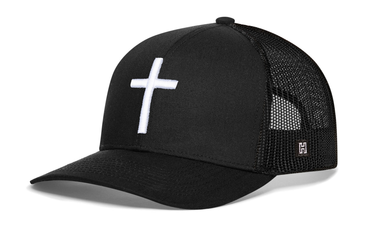 Black cross trucker hat with white cross logo and black mesh back