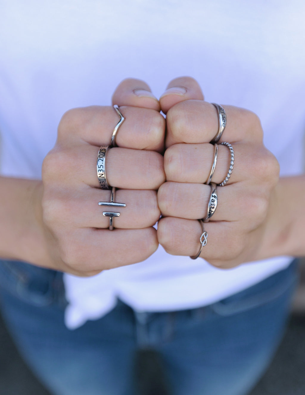 Silver double bar ring on a finger, featuring two vertical bars on the band