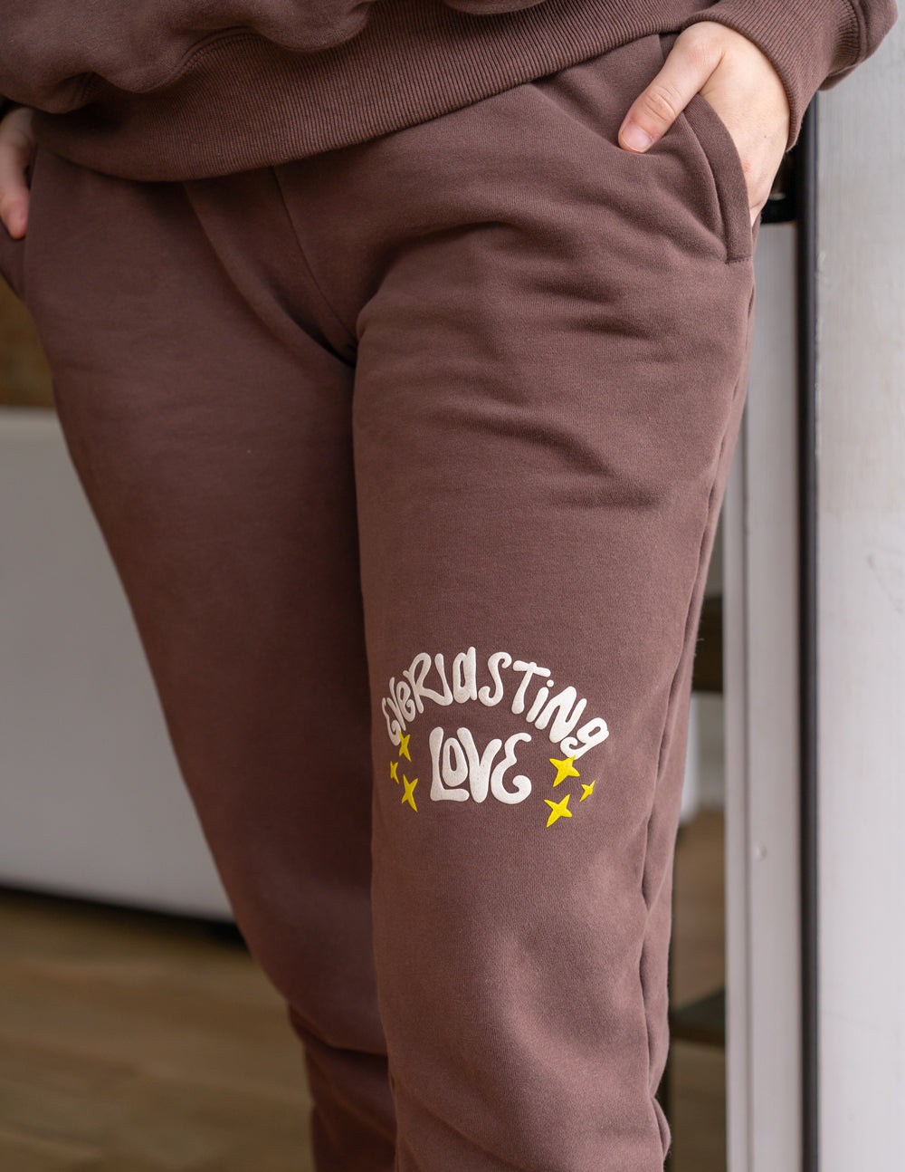 Unisex brown sweatpants with Love star logo on back leg, tapered ankle